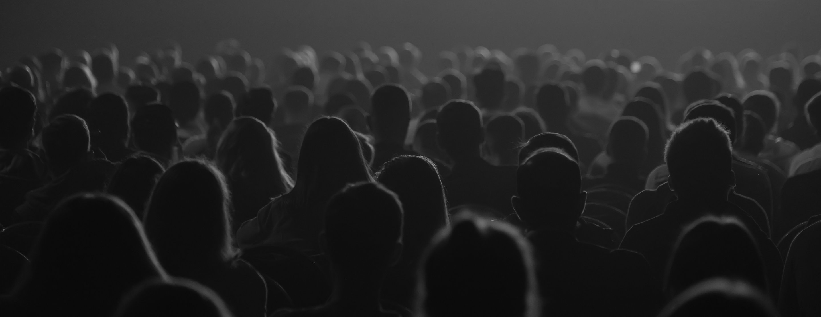 Unrecognizable people listening to speaker during business conference