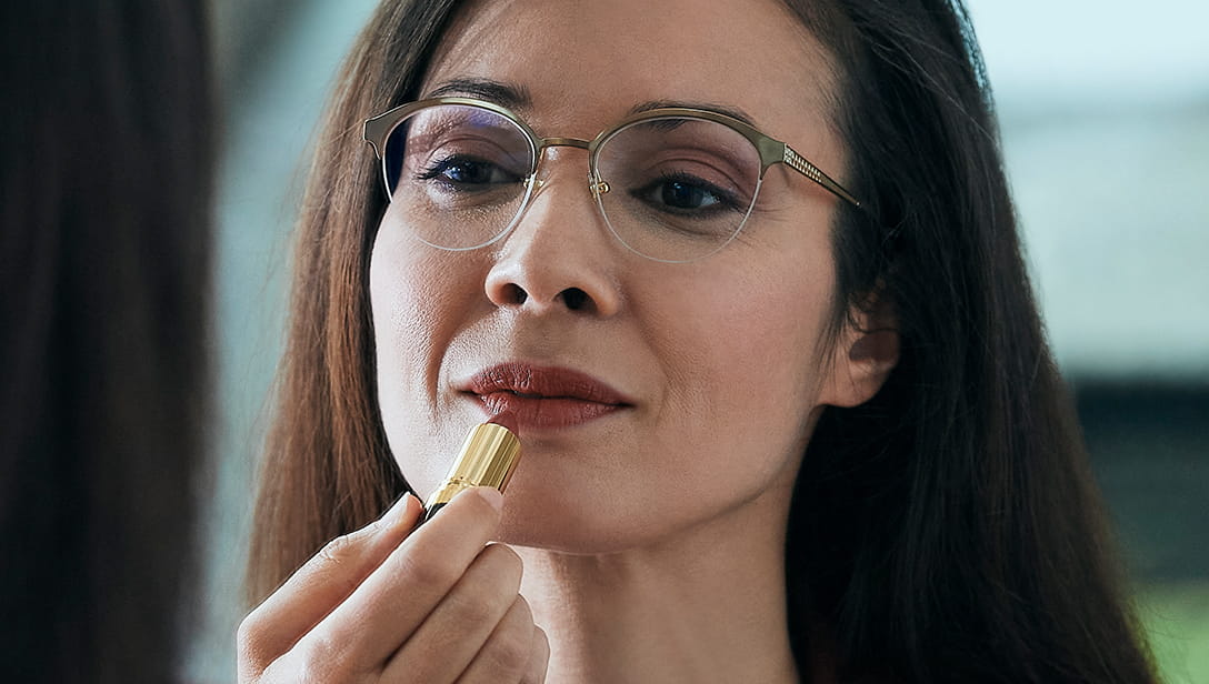 Woman applying lipstick